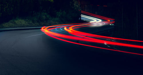 Light trails on road in city at night