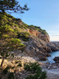 Rock formations by sea against sky