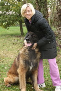 Portrait of woman with dog on grass