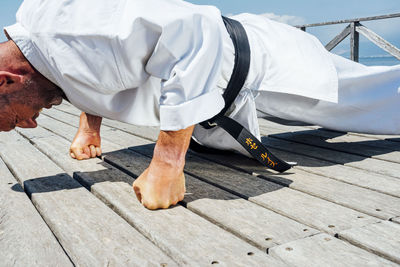 Karate man stand, rests all your weight on the fists. close-up image