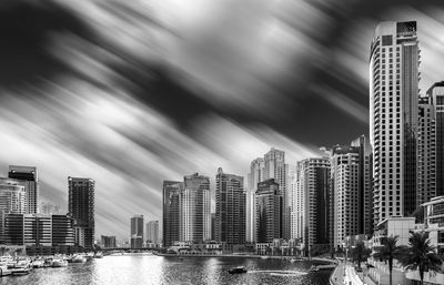 Panoramic view of river amidst buildings against sky