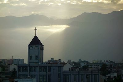 Buildings against mountain range