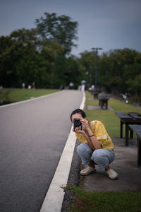 Series photo of young women wearing surgical protection mask playing with camera in the evening