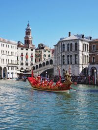 View of boats in canal along buildings