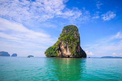 Rock formations in sea against sky