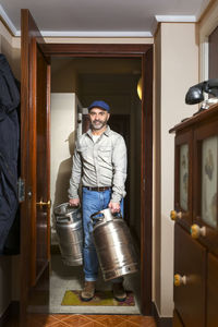 Man carrying gas cylinder at home