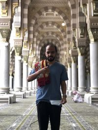 Portrait of young man standing in city