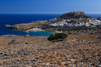 View of coastal town and boats in lindos bay, greece