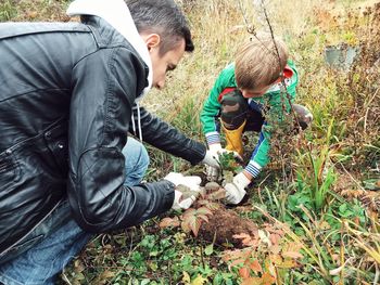 Father and son planting in garden