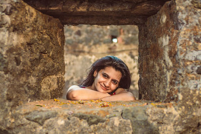 Portrait of smiling woman on rock