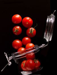 Close-up of red tomatoes against black background