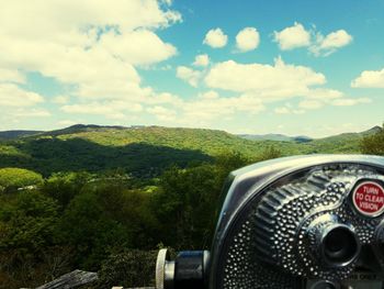 Close-up of car on landscape against sky