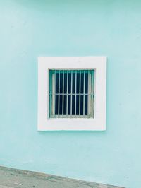 Window on white wall of building