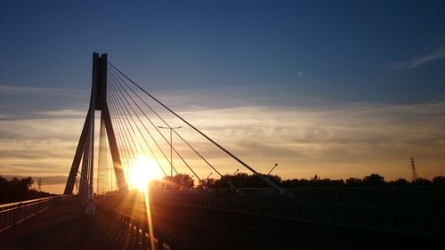 Silhouette bridge against sky during sunset