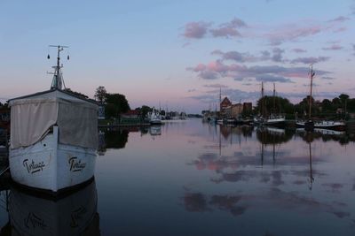 Reflection of built structure in water against sky