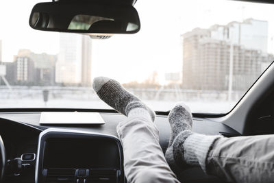 Man with feet on dashboard in car