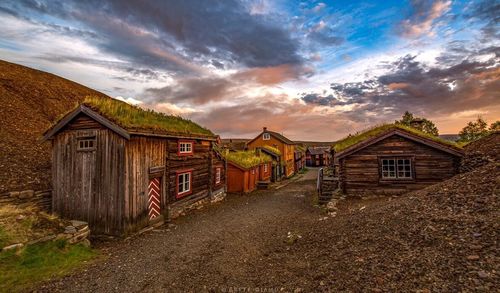 Houses against cloudy sky