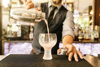 Bartender making drink at bar