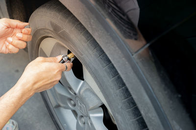 Cropped hand of woman tightening car wheel