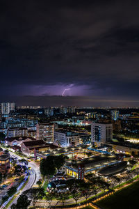 High angle view of illuminated cityscape against sky at night