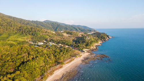 Scenic view of sea and mountains against sky