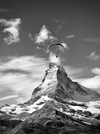 Low angle view of snowcapped mountain against sky