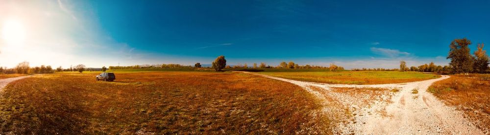 Panoramic view of agricultural field against sky