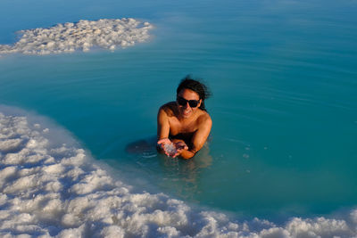 Rear view of woman swimming in sea