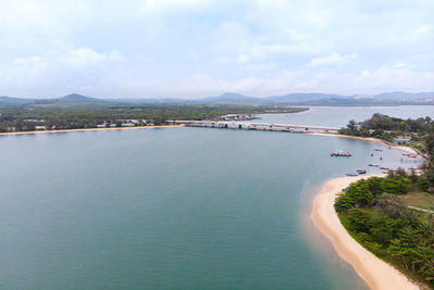 High angle view of sea and city against sky