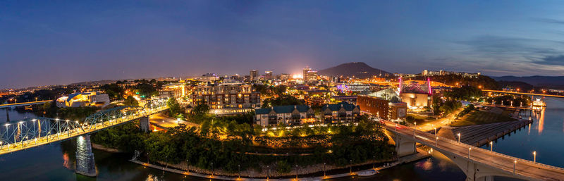 High angle view of illuminated buildings against sky at night