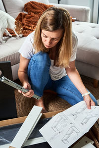 Young woman sitting on paper