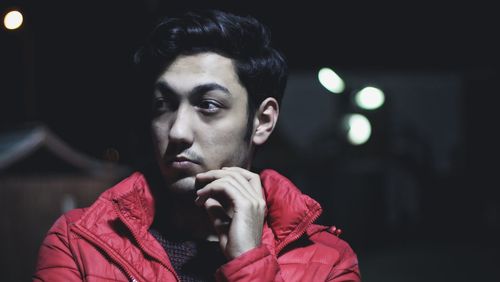 Portrait of young man looking at night
