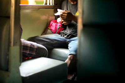 Man sitting on seat in bus