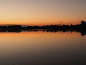 Scenic view of lake at sunset