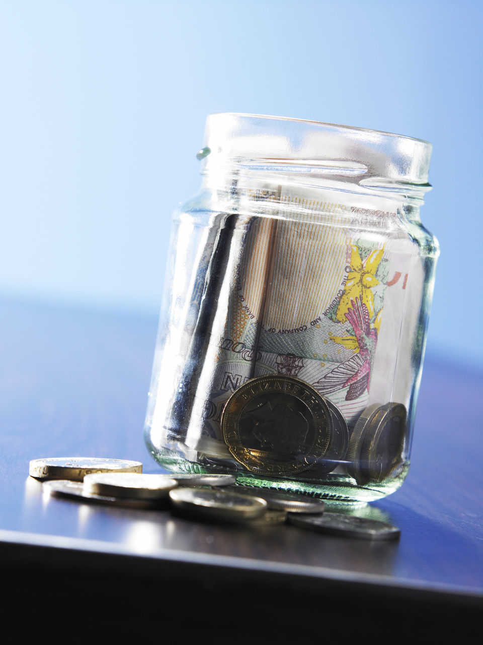 CLOSE-UP OF JAR AGAINST COLORED BACKGROUND