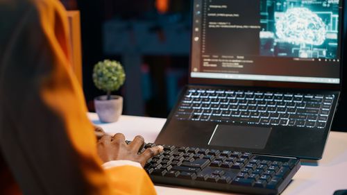 Midsection of man using laptop
