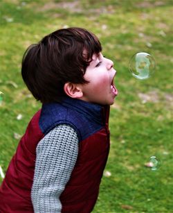 Close-up of boy playing with bubble