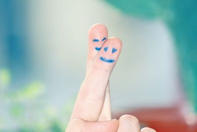 Cropped image of fingers with smiley faces