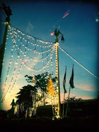 Low angle view of illuminated street light against sky