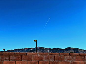 Low angle view of vapor trail against blue sky