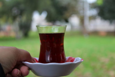 Close-up of hand holding drink