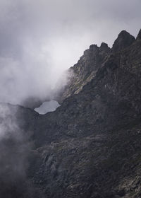 Smoke emitting from volcanic mountain against sky