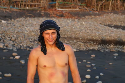 Portrait of smiling young man standing on land