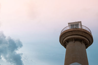 Low angle view of tower amidst buildings against sky