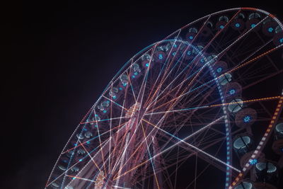 Low angle view of ferris wheel against sky at night