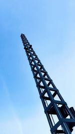 Low angle view of crane against clear blue sky