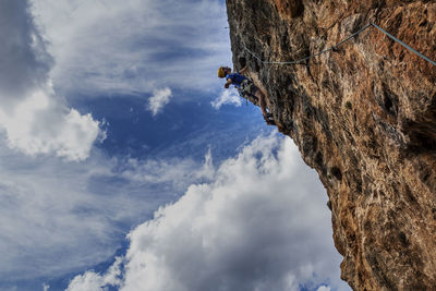 Low angle view of mountain range against cloudy sky