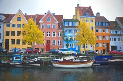 Boats in canal with buildings in background