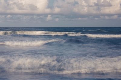 Scenic view of sea against cloudy sky