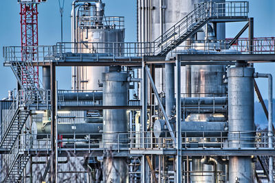 Complex pipe structure against blue sky